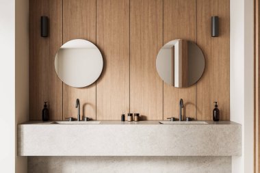 Yuvarlak aynalar, ahşap paneller ve taştan bir tezgahta çift lavabo olan şık bir banyo. Minimalist modern tasarım konsepti. 3B Hazırlama.
