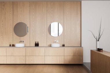 Çağdaş banyo içi ahşap paneller, yuvarlak aynalar ve lavabolarla dolu. Tarafsız bir arkaplanda estetik dekor. Modern tasarım kavramı. 3B Hazırlama