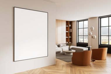 Temiz bir duvarda boş çerçeveli bir poster modeli olan minimalist bir iç mekan. Ahşap döşeme, rahat mobilyalar ve büyük pencereler sıcak bir ortam yaratır. 3B Hazırlama.