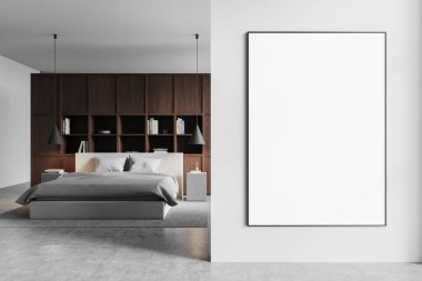 Ahşap rafları, rahat yatağı ve beyaz bir duvarda boş çerçeveli posteri olan çağdaş bir yatak odası. Kolye ışıkları ve nötr tonları olan minimalist bir dekor. 3B Hazırlama