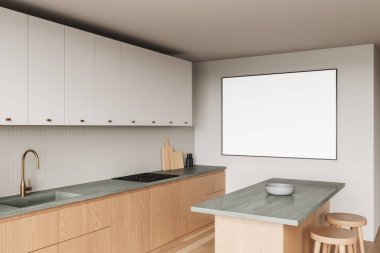 Ahşap dolapları, mermer tezgahı ve duvarında boş çerçeveli posteri olan parlak bir mutfak. Tarafsız tonlarda minimalist tasarım. 3B Hazırlama