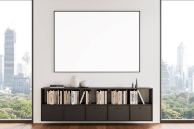Modern bir kitaplığın üstündeki temiz bir duvara boş bir poster çerçevesi, kitaplar ve dekorlarla dolu, ahşap zemin ve geniş pencereli parlak bir odada. 3B Hazırlama