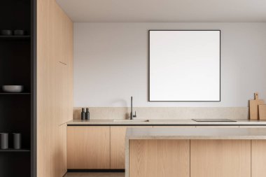 Hafif ahşap dolaplı modern mutfak, beyaz duvarda boş kare poster modeli, temiz yüzeyli minimalist düzen. 3B Hazırlama