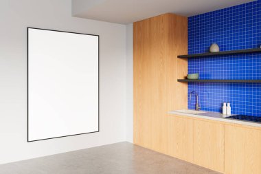 Temiz beyaz bir duvara asılmış boş çerçeveli poster modeli, ahşap dolapları ve mavi seramikli arka kaplaması olan modern bir mutfağın yanında, minimalist 3D görüntüleme.
