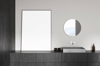 Karanlık ahşap dolaba yaslanmış boş bir poster, minimalist taş lavabo ve yuvarlak ayna, modern temiz iç tasarım konsepti. 3B Hazırlama