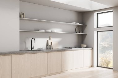 Hafif ahşap dolapları, beton tezgahları, açık rafları ve yumuşak gün ışığında geniş pencereleri olan minimalist mutfak. 3B Hazırlama