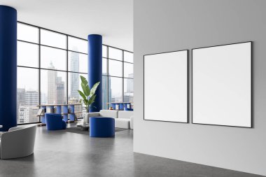 Mavi sütunları, modern mobilyaları ve şehir manzarasını gösteren büyük pencereleri olan şık bir ofis içinde gri duvarda iki boş poster çerçevesi. 3B Hazırlama