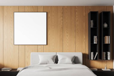 Ahşap duvarda boş beyaz poster çerçevesi, yumuşak yatak örtüsü ve dikey raf üniteleri olan modern bir yatak odası. 3B Hazırlama