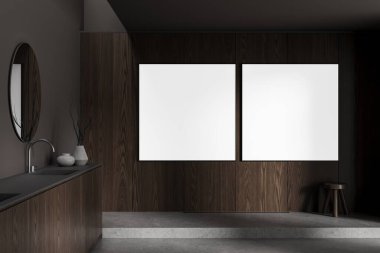 Modern banyo içerisindeki koyu ahşap duvarda iki adet boş poster modeli. Temiz tasarım, hafif ışık ve minimum tasarım. 3B Hazırlama