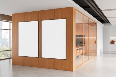 Modern ofis içinde ahşap duvar köşesine çerçevelenmiş iki boş poster, temiz minimal tasarım, cam toplantı odası arka planı, tasarım konsepti. 3B Hazırlama