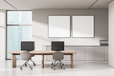 Minimalist office with two computers on a wooden desk, two blank posters on wall, daylight from window, concept of workspace mockup and design. 3D Rendering