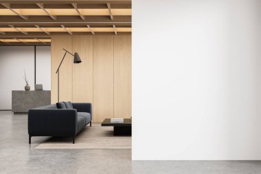 Minimalist office interior with dark sofa and wooden panels, next to empty white wall for poster, concept or design mockup in bright open space. 3D Rendering