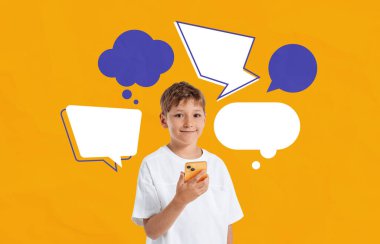 Happy child boy holding a smartphone with various speech and thought bubbles around him, isolated on bright orange background, concept of communication