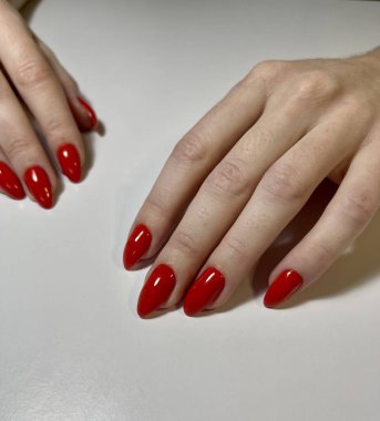 Oval şekilli tırnaklarda kırmızı manikür.