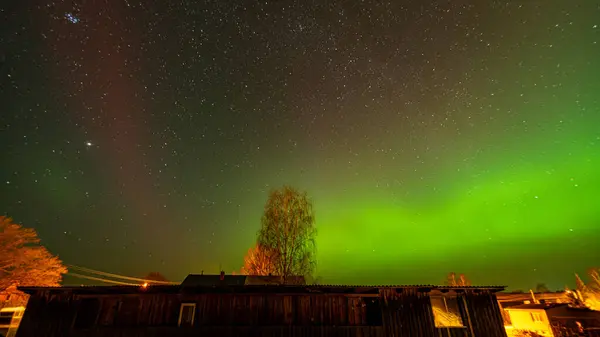 stock image colorful northern lights, view from the window, northern lights in spring, Latvia