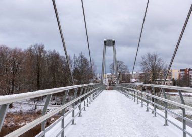 winter landscape with a bridge over the river, winter day, snow-covered trees, Gauja River near Valmiera, Latvia clipart