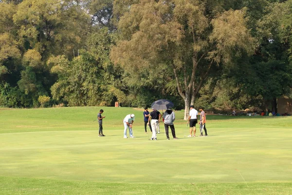 stock image December 25 2022 - Vadodara, Baroda, Gujarat in India: People play golf near the Laxmi Vilas Palace