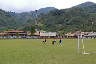 March 3 2023 - Orosi in Costa Rica: Football playing children in the center of the village clipart