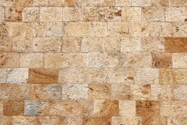 Sarı bej doğal taş duvar, farklı boyutlarda taşlar, geleneksel el sanatları