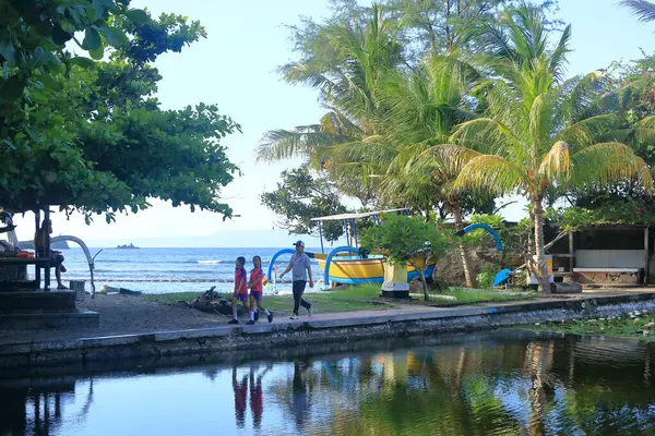 Stock image Candidasa, Bali in Indonesia - February 6 2024: Children, students of state elementary school enjoy morning sport