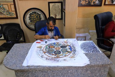 Madaba, Ürdün - 09 Mayıs 2024: Yerel halk el sanatları atölyesinde sanat ürünleri üretiyor