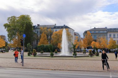 30 Ekim 2023 - Almanya 'da Potsdam: Sonbaharda Brandenburg Kapısı yakınlarındaki Luisenplatz' da çeşme. Yakında turistler var