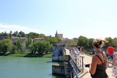 Avignon, France in Europe - August 25 2024: people enjoy the Pont Saint Benezet bridge and Rhone river clipart