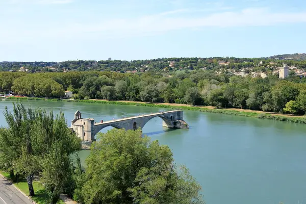 stock image Avignon, France in Europe - August 25 2024: people enjoy the Pont Saint Benezet bridge and Rhone river