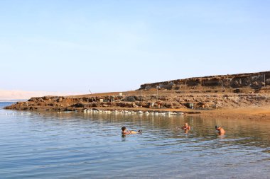 Sweimeh, Swemeh, Dead Sea in Jordan - May 09 2024: people bathing in the water of the dead sea clipart