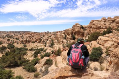 Dana Biosphere Nature Reserve in Jordan - May 12 2024: People are hiking in the desert rock landscape clipart