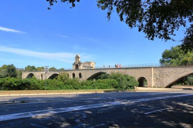 Avignon, France in Europe - August 25 2024: people enjoy the Pont Saint Benezet bridge and Rhone river clipart