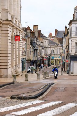 Auxerre, France in Europe - September 05 2024: people explore the old streets and houses of the city on a cloudy day clipart