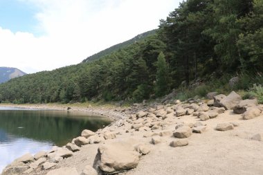 Dry lake in the process of drought and lack of rain or moisture, Estany d'Engolasters lake, Andorra clipart