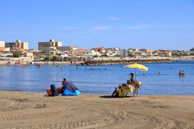 Carnon, Palavas-les-Flots, Montpellier, Fransa - 25 Ağustos 2024: İnsanlar Montpellier 'in güneyinde bir sahil beldesi olan Carnon Plage' ın tadını çıkarıyor