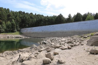 Dry lake in the process of drought and lack of rain or moisture, Estany d'Engolasters lake, Andorra clipart