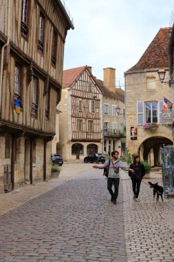 Noyers sur Serein in France, Europe - September 04 2024: Typical streets with old houses and some people clipart