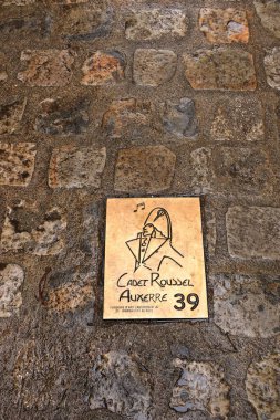 Auxerre, France in Europe - September 05 2024: people explore the old streets and houses of the city on a cloudy day clipart