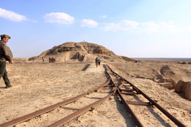 Uruk in Iraq - November 12 2024: tourists visit the excavation site in the Ancient City of Uruk clipart