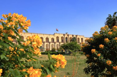 Baghdad, Bagdad in Iraq - November 15 2024: Outdoor view of the Al Qishla (Qushla) Palace at the Tigris river clipart