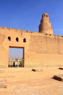 Samarra in Iraq - November 16 2024: people inside the walls of the Great Mosque Malwiya clipart