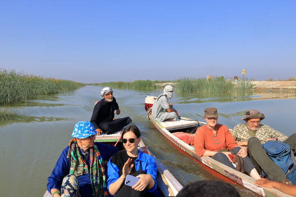 Chibayish, Chabaish, Nasiriya in Iraq - November 11 2024: people on a boat trip in the marshlands of iraq