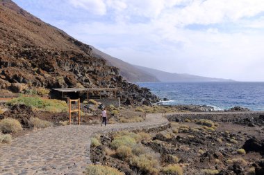 El Hierro 'da. İspanya 'daki Kanarya Adaları - Aralık 05 2025: İnsanlar Muelle de Orchilla' daki güzel kıyı şeridinin tadını çıkarıyor