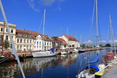 Almanya 'da Ueckermuende, Mecklenburg-Batı Pomeranya - 25 Temmuz 2025: İnsanlar güneşli bir günde şehrin limanının keyfini çıkarıyorlar