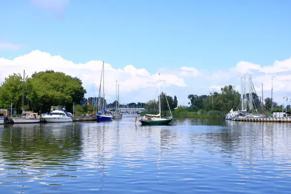 Almanya 'da Ueckermuende, Mecklenburg-Batı Pomeranya - 25 Temmuz 2025: İnsanlar güneşli bir günde şehrin limanının keyfini çıkarıyorlar