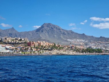 Tenerife 'nin kıyı şeridi boyunca uzanan dinlendirici bir yat gezisi Teide volkanı, durgun okyanus suları ve bulutsuz bir gökyüzü ile birlikte adaları nefes kesici bir manzara ile sergiliyor..