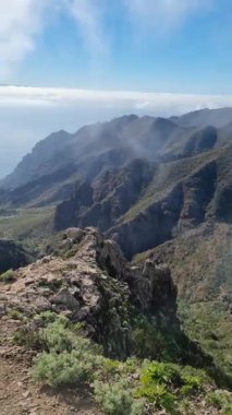 Tenerife, Kanarya Adaları 'ndaki Anaga Parkı' ndan nefes kesici bir manzara. Puslu, engebeli dağları ve yemyeşil vadileri yakalıyor. Huzurlu ve dramatik bir manzara sunuyor..