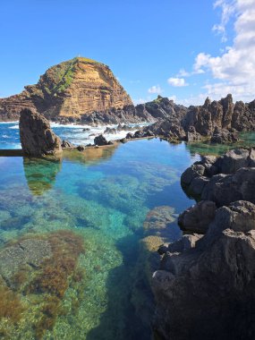 Porto Moniz, Madeira, Portekiz 'de lav bazlı yüzme havuzları dramatik kaya dokuları ve şeffaf turkuaz suları olan doğa severler için ikonik bir yerdir..