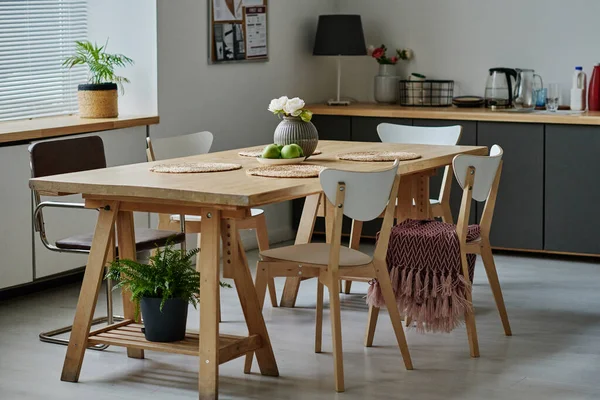 stock image Horizontal image of modern kitchen with wooden dining table in the centre of the room