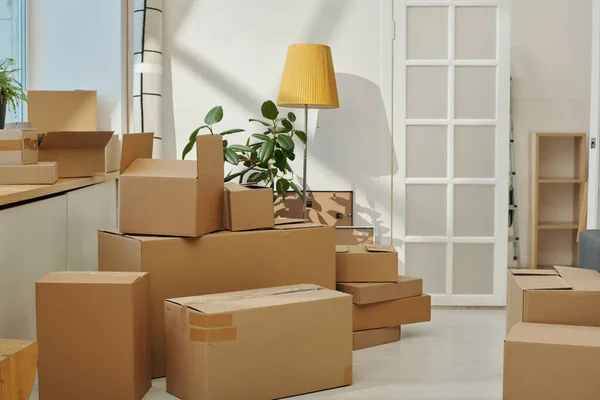 stock image Horizontal image of cardboard boxes standing around the room preparing for moving