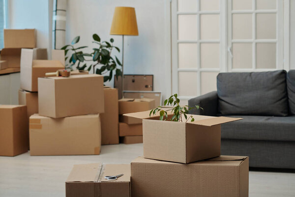Horizontal image of packed and unpacked boxes in the new apartment
